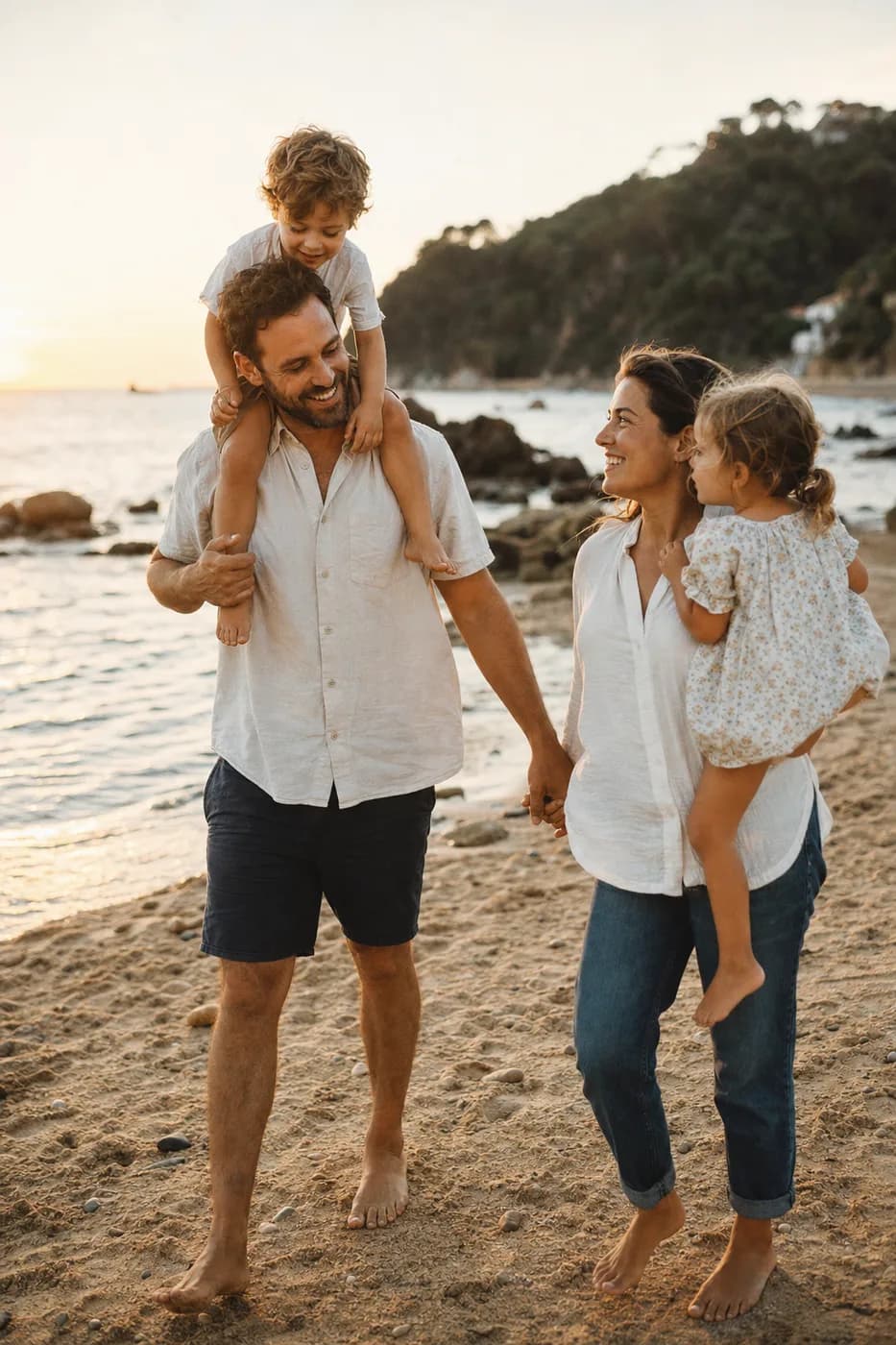 A young family on a sunny beach vacation at golden hour